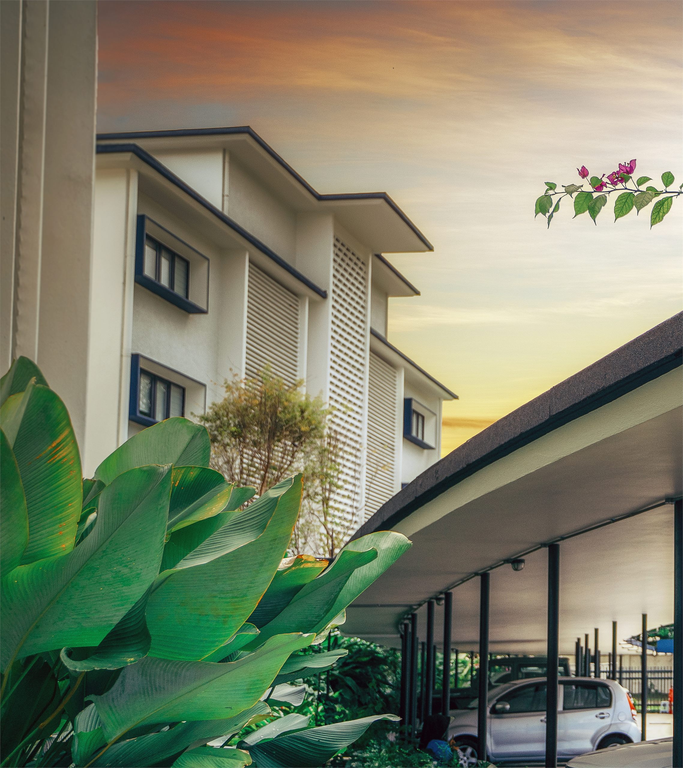 Building facade framed by bougainvillea at The Stories of Taman Tunku