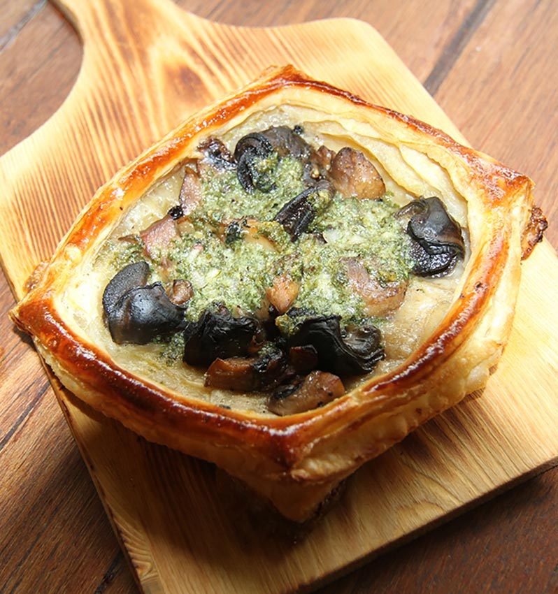 Savoury tart topped with olives and herbs at Kenny Hills Bakers & Bistro