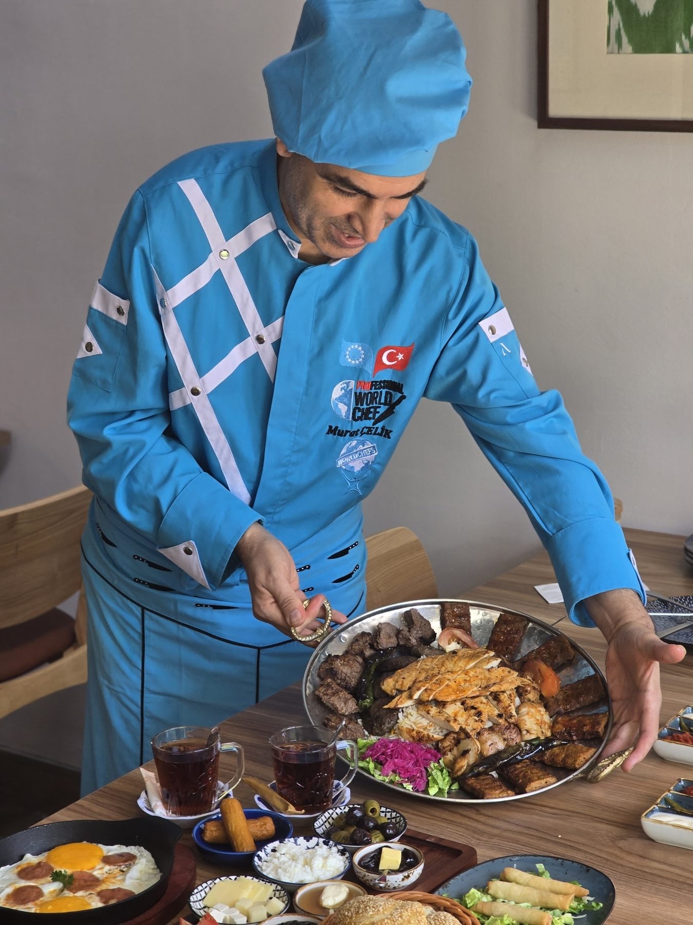 Chef in traditional dress cooking at Turks KL