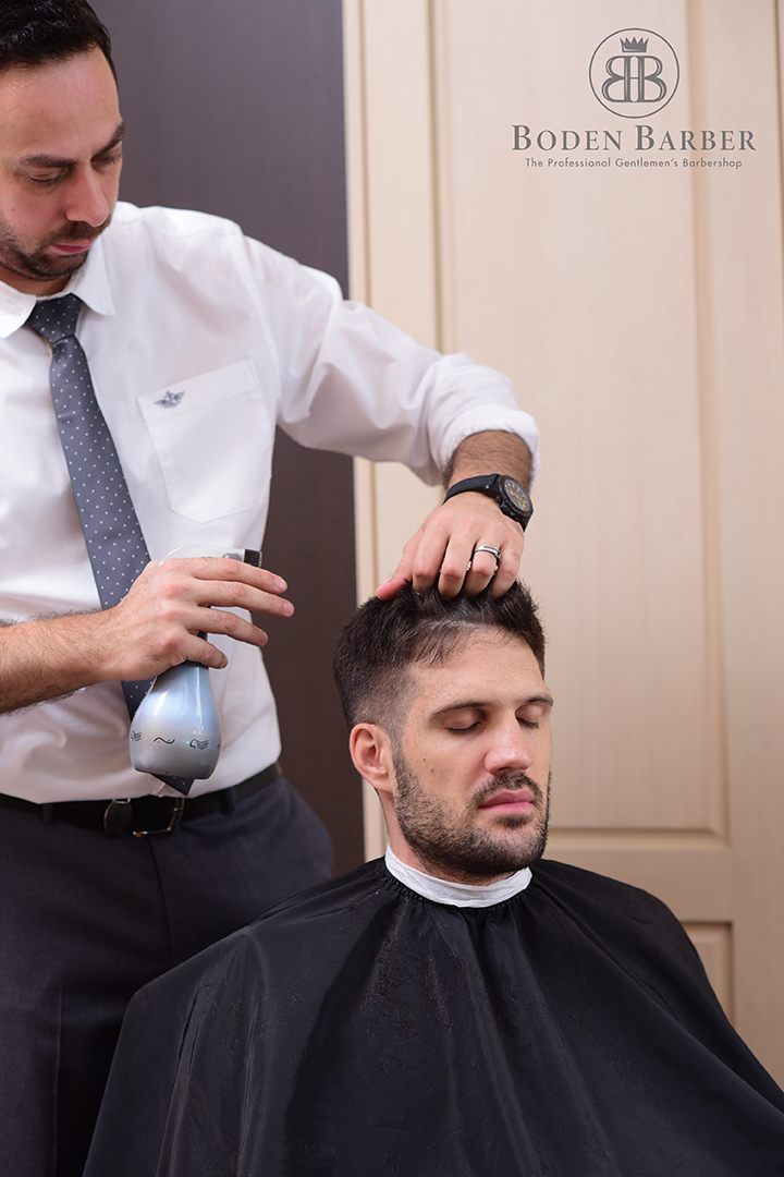 Barber attending to a seated client at Boden Barber