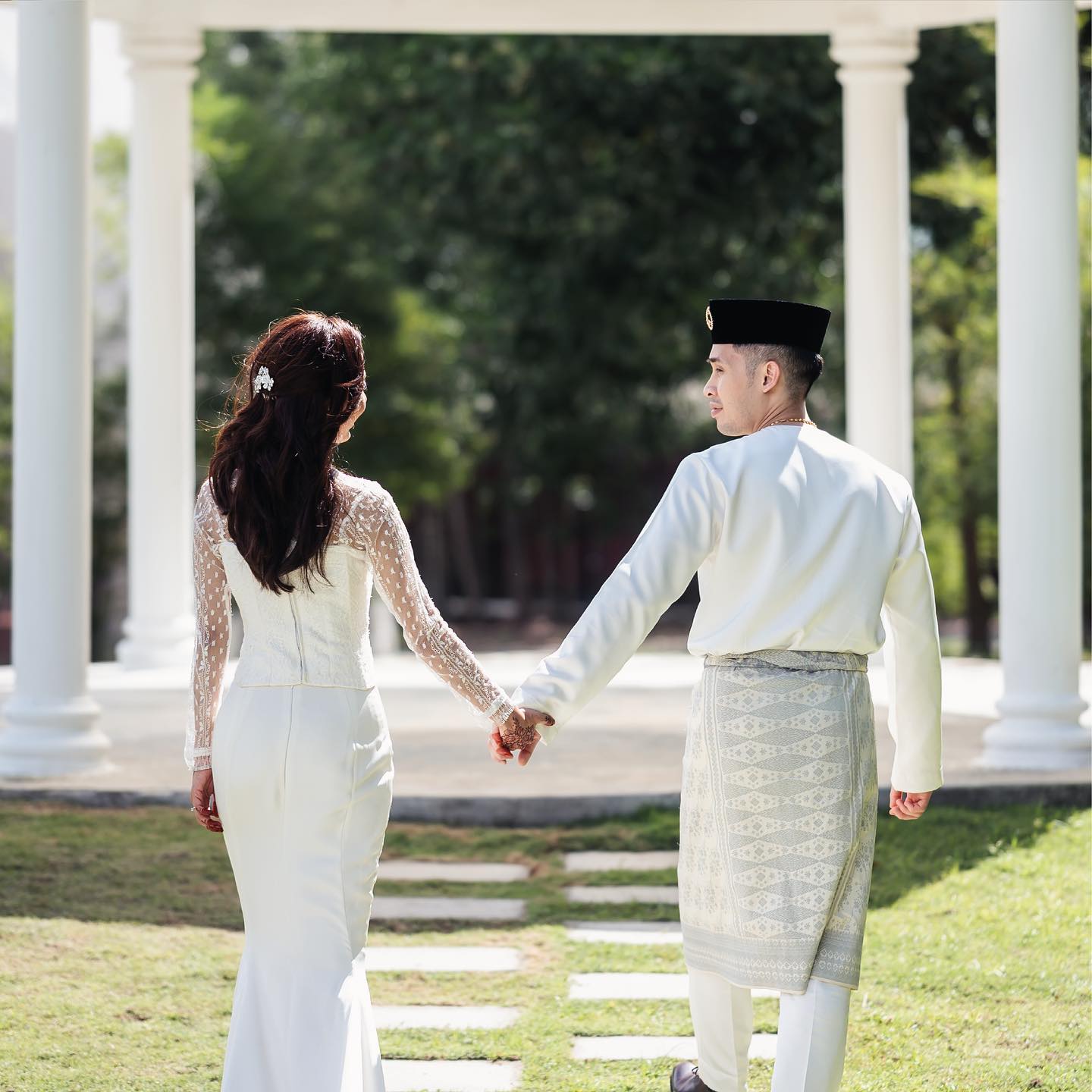 Couple in traditional wedding attire by Omar Ali